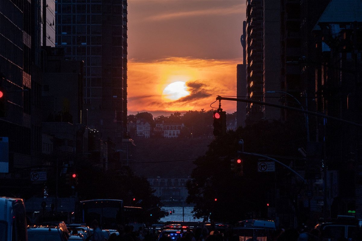 <i>Jeenah Moon/Reuters</i><br/>The sun sets while lined up with 42nd Street in Manhattan on July 11
