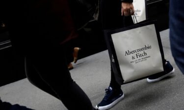 A person carries a bag from the Abercrombie & Fitch store on Fifth Avenue in Manhattan