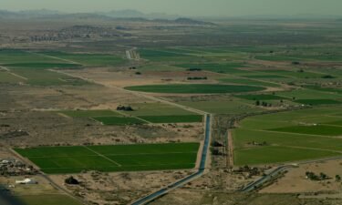 A canal runs through farm land in near the California-Arizona border on April 4