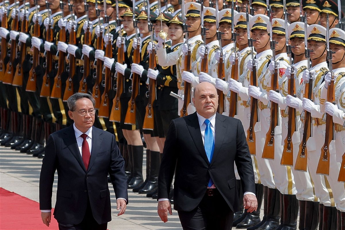 <i>Thomas Peter/AFP/Getty Images</i><br/>Russian Prime Minister Mikhail Mishustin and Chinese Premier Li Qiang attend a welcoming ceremony in Beijing on May 24.