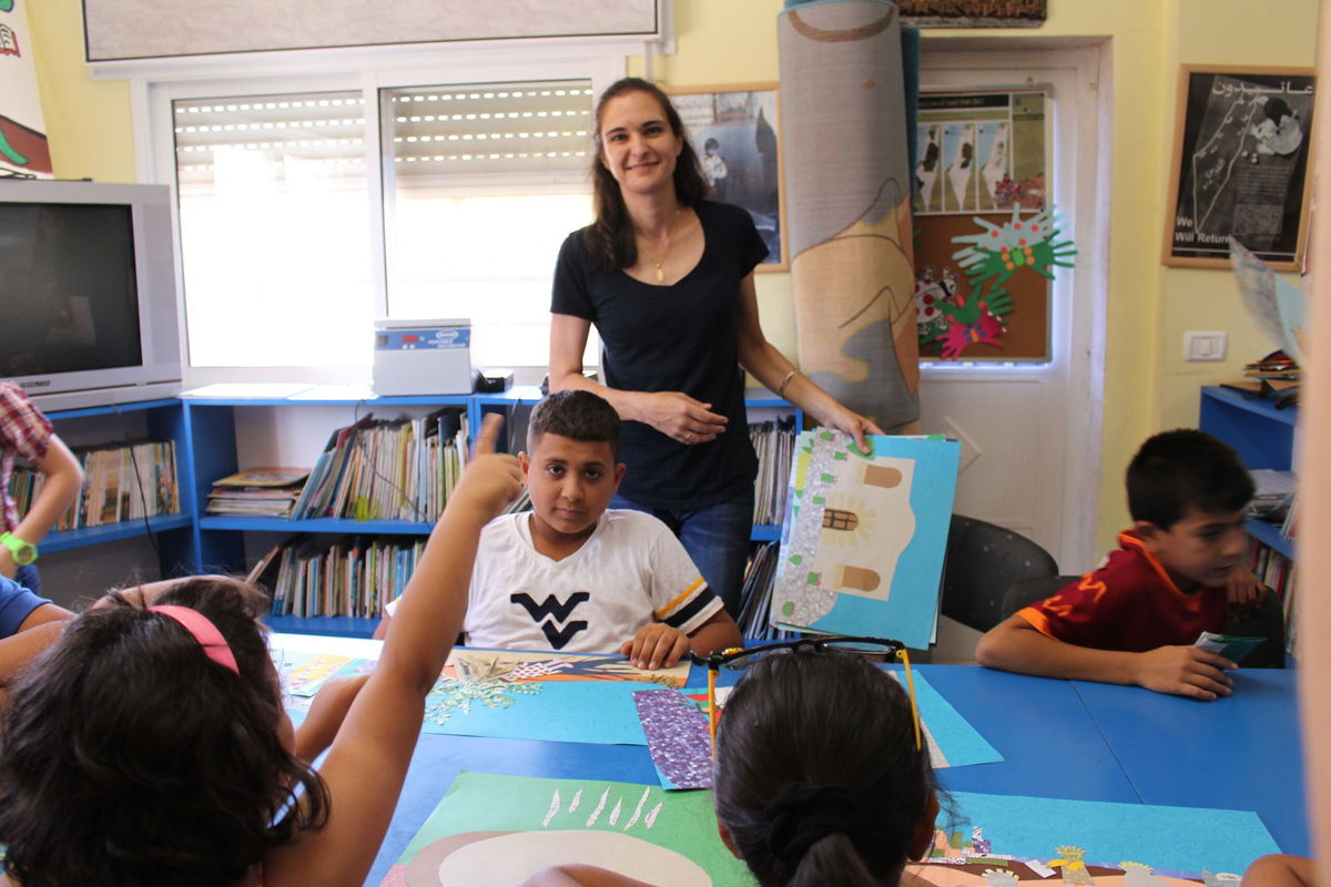 <i>Courtesy Nidal Al-Azraq</i><br/>Amahl Bishara helps Palestinian children at Aida Refugee Camp create an alphabet book about their childhood.