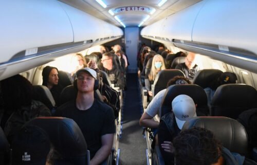 Airline passengers sit during an American Airlines flight operated by SkyWest Airlines from Los Angeles International Airport (LAX) to Denver