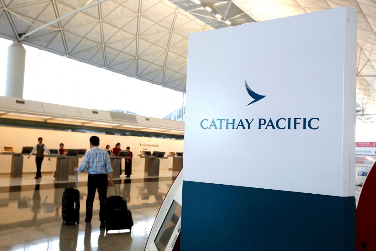 <i>Bobby Yip/Reuters</i><br/>A passenger walking to a Cathay Pacific counter at Hong Kong's international airport in 2018. The airline made headlines this week over an incident of alleged discrimination with a passenger from mainland China.