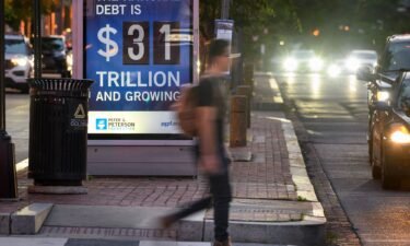 A poster at a bus shelter shows the national debt in Washington