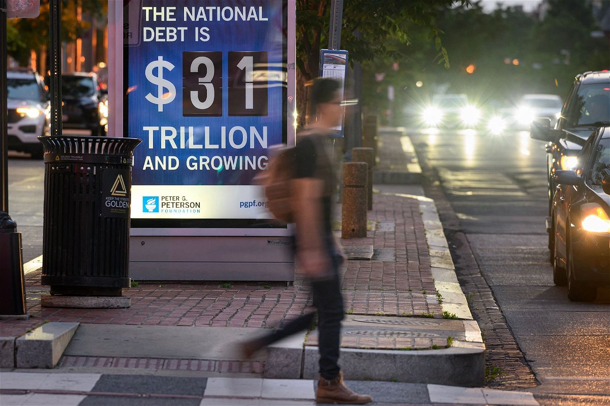 <i>Mandel Ngan/AFP/Getty Images</i><br/>A poster at a bus shelter shows the national debt in Washington
