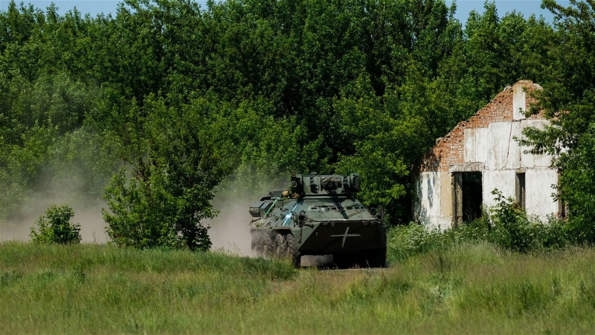 <i>Vasco Cotovio/CNN</i><br/>A Ukrainian BTR armored personnel carrier races across a field as part of a military drill.