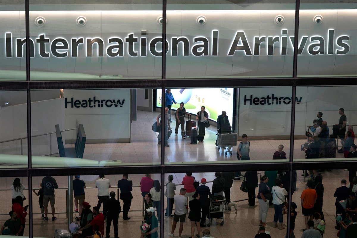 <i>Kin Cheung/AP</i><br/>Passengers arrive at Heathrow Airport