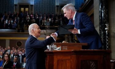 President Joe Biden shakes hands as he presents a copy of his speech to House Speaker Kevin McCarthy before he delivers his State of the Union address to a joint session of Congress