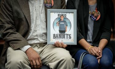 Felix Rubio holds a picture of Lexi as he sits next to Kim at a US House Oversight Committee hearing titled