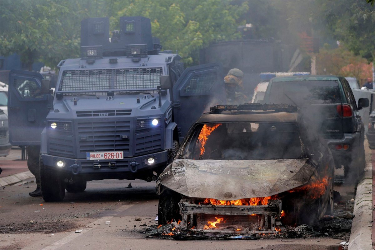 <i>Valdrin Xhemaj/Reuters</i><br/>A car was set on fire during Monday's clashes.