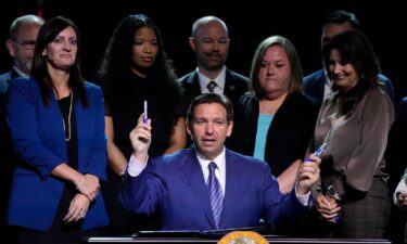 Florida Gov. Ron DeSantis on Wednesday signed into law new restrictions on trans Floridians’ access to treatments and bathrooms. DeSantis is pictured here during a signing ceremony at Lighthouse Point