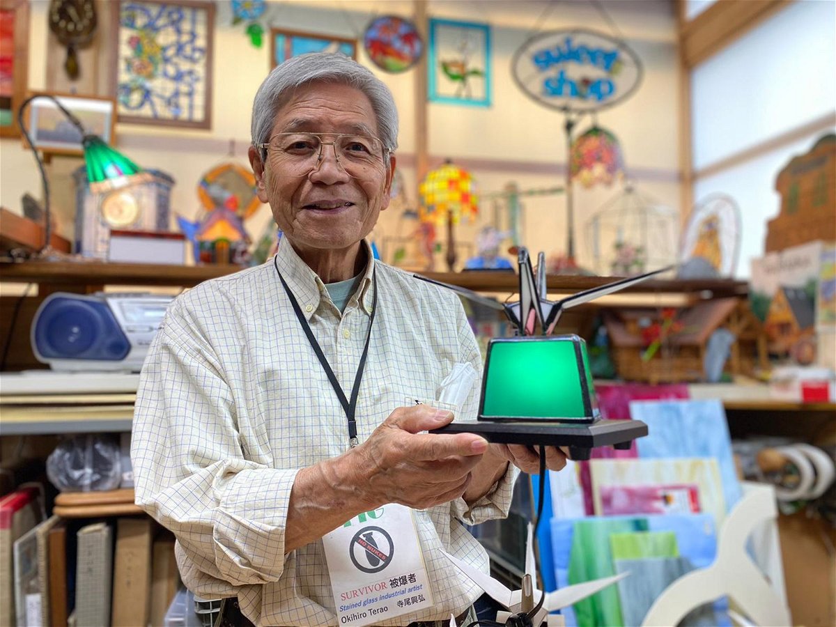 <i>Emiko Jozuka/CNN</i><br/>Okihiro Terao holds up a stained-glass crane that he made to symbolize peace. He said he sent one decorated in the colors of the Ukrainian flag to the Ukrainian embassy in Tokyo.