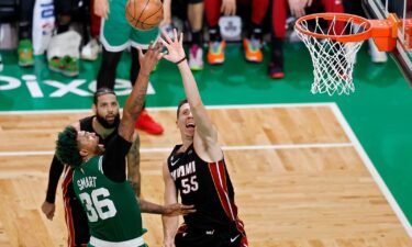 Boston Celtics guard Marcus Smart (36) and Miami Heat forward Duncan Robinson (55) reach for a rebound during the second half in Game 7 of the NBA basketball Eastern Conference finals Monday in Boston.