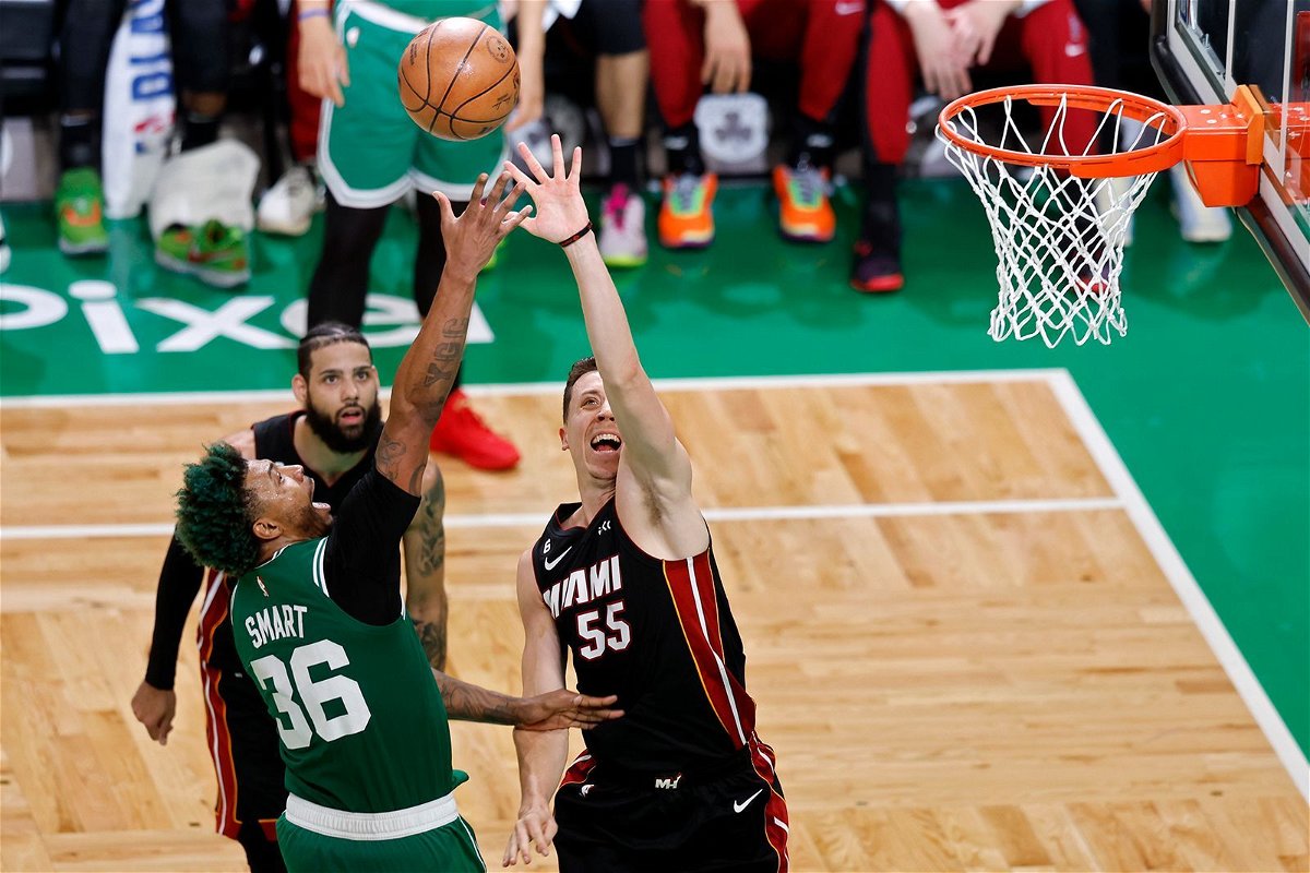<i>Michael Dwyer/AP</i><br/>Boston Celtics guard Marcus Smart (36) and Miami Heat forward Duncan Robinson (55) reach for a rebound during the second half in Game 7 of the NBA basketball Eastern Conference finals Monday in Boston.