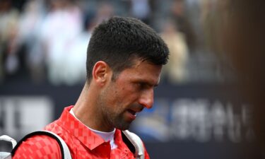 Novak Djokovic leaves the court after losing his quarterfinal match against Denmark's Holger Rune.