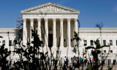 People visit the front of the U.S. Supreme Court Building on April 19
