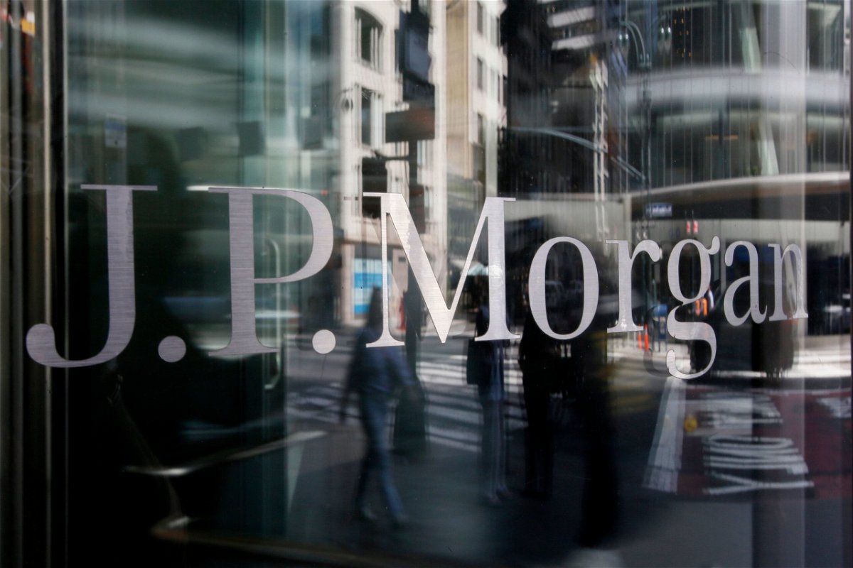<i>Leonardo Munoz/VIEWpress/Corbis News/Getty Images</i><br/>People are reflected into a J.P.Morgan Chase & Co window on April 14 in New York City. JPMorgan is letting go of about 500 employees across the bank.