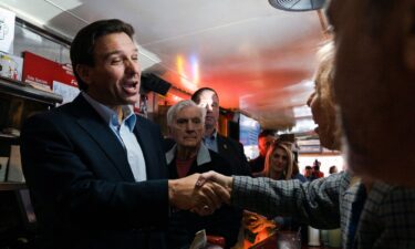 Florida Gov. Ron DeSantis greets people at a diner in Manchester