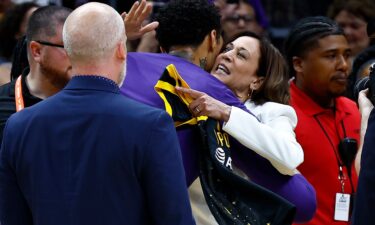 Vice President Kamala Harris hugs Brittney Griner before the game.