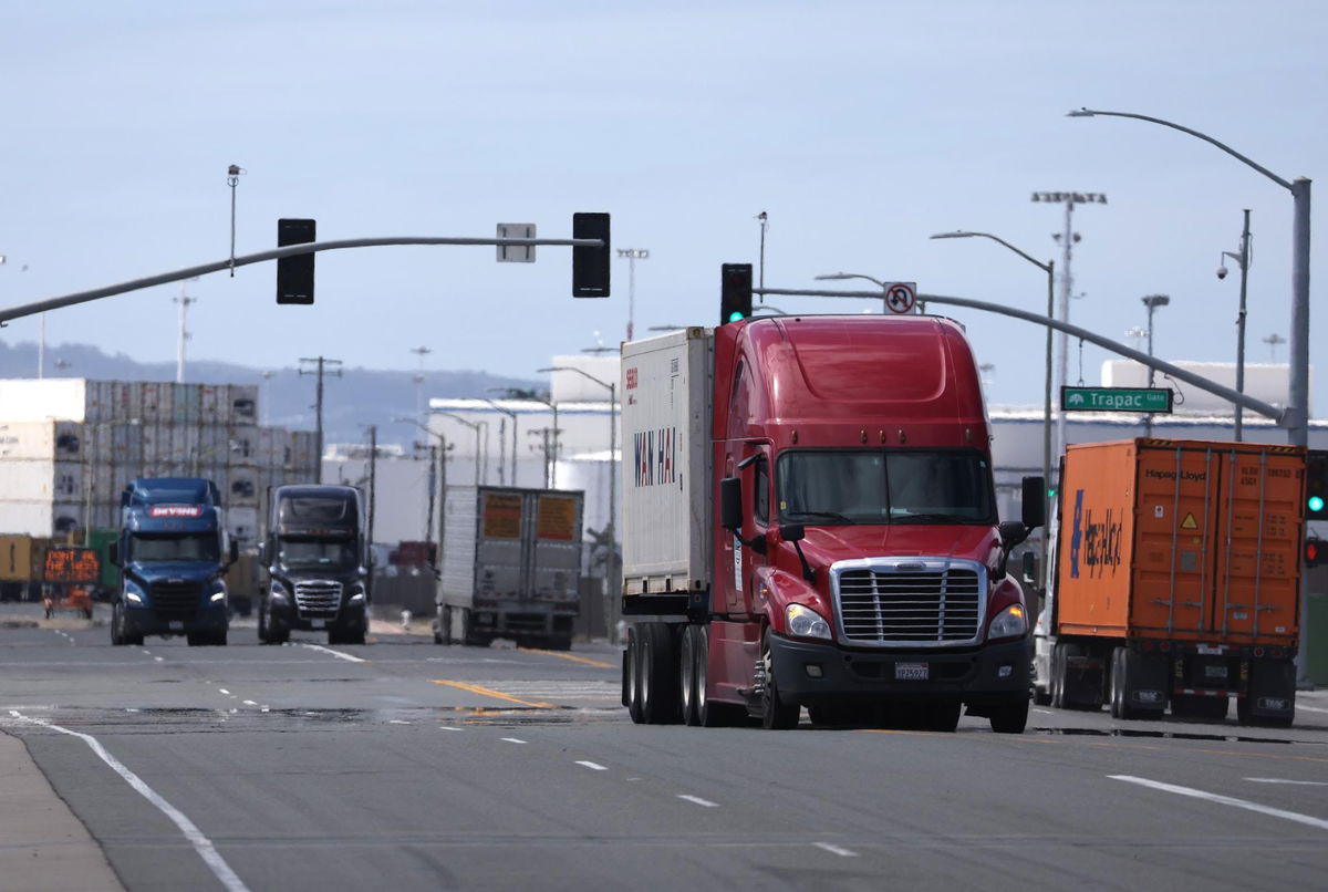 <i>Justin Sullivan/Getty Images</i><br/>Trucks drive through the Port of Oakland on March 31 in Oakland