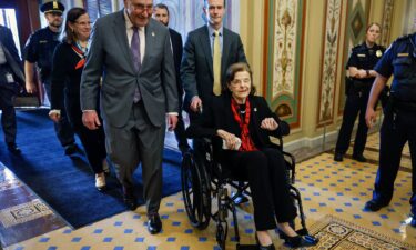 Senate Majority Leader Charles Schumer escorts Sen. Dianne Feinstein as she arrives at the Capitol following a long absence due to health issues on May 10 in Washington