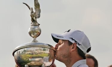 Emiliano Grillo kisses the trophy after winning the Charles Schwab Challenge.