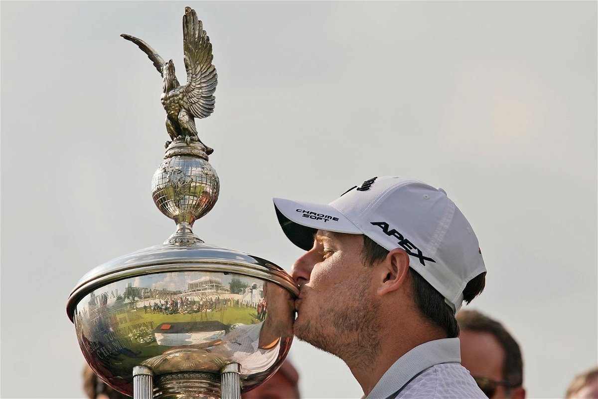 <i>LM Otero/AP</i><br/>Emiliano Grillo kisses the trophy after winning the Charles Schwab Challenge.