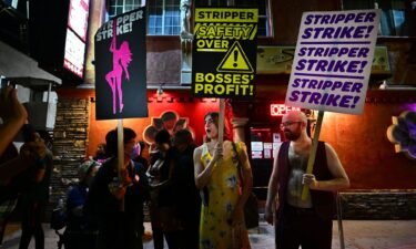 Supporters join strippers for a rally outside the Star Garden Topless Dive Bar on August 19