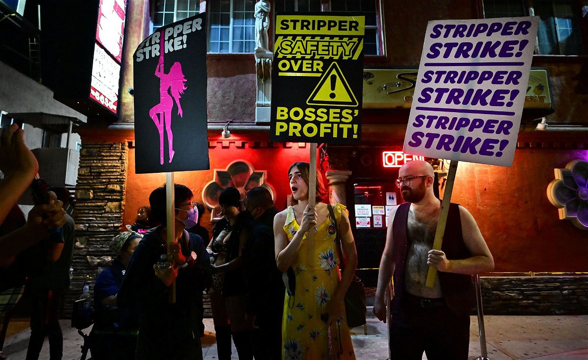 <i>Frederic J. Brown/AFP/Getty Images</i><br/>Supporters join strippers for a rally outside the Star Garden Topless Dive Bar on August 19