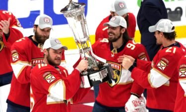 Florida Panthers center Aleksander Barkov holds the Prince of Wales trophy after the Panthers won Game 4 of the NHL hockey Stanley Cup Eastern Conference finals against the Carolina Hurricanes in Sunrise
