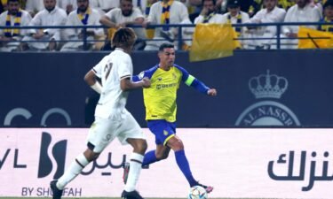 Shabab defender Fawaz al-Sqoor defends against Portuguese forward Cristiano Ronaldo during the Saudi Pro League match between Al-Nassr and Al-Shabab on May 23.