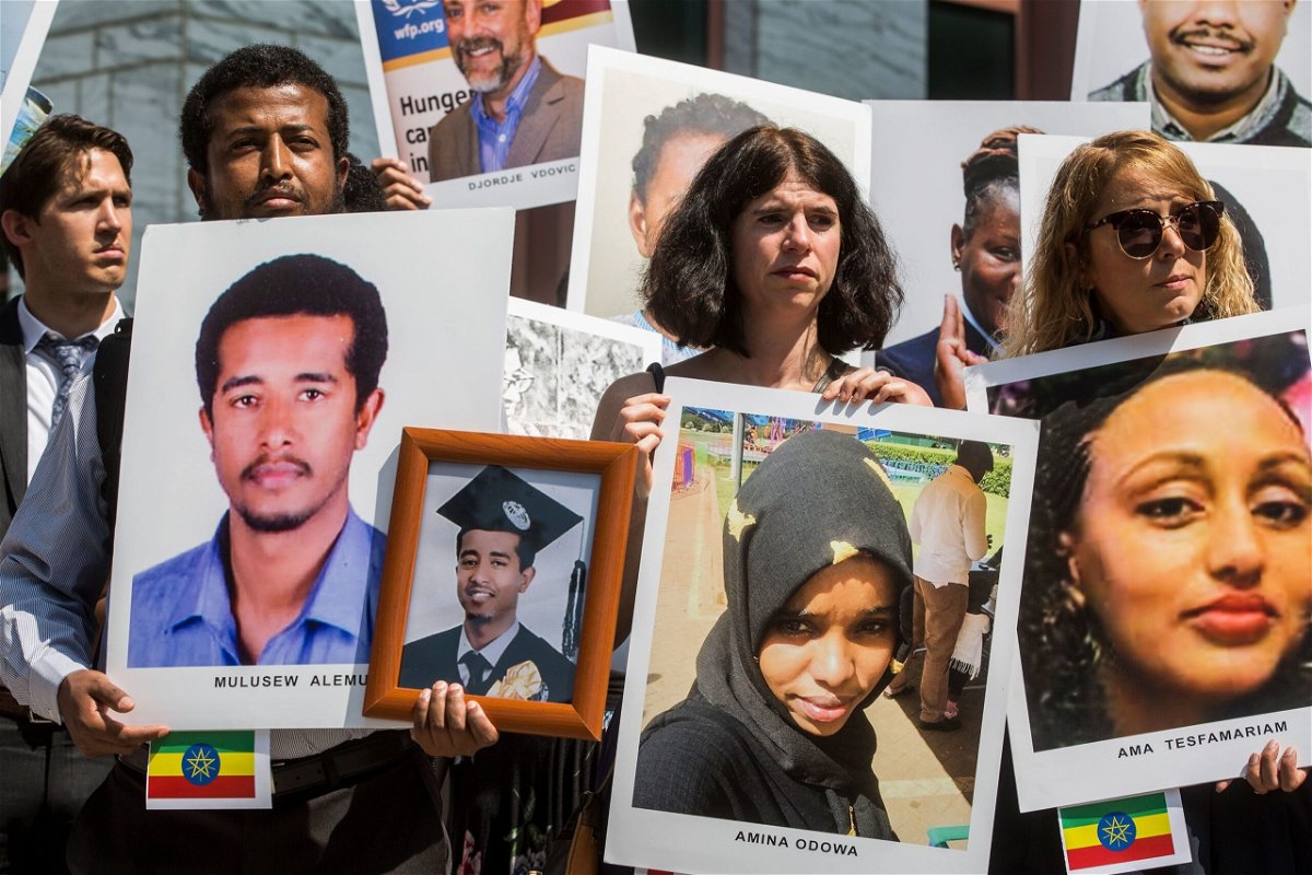 <i>Zach Gibson/Getty Images</i><br/>People hold signs during a vigil for victims of the Ethiopian Airlines Flight ET302 crash on September 10