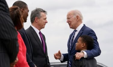 President Joe Biden talks with North Carolina Gov. Roy Cooper as he arrives at Piedmont Triad International Airport in Greensboro in April 2022.