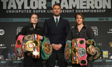 Katie Taylor (left) and Chantelle Cameron (right) pose with promoter Eddie Hearn during a press conference.