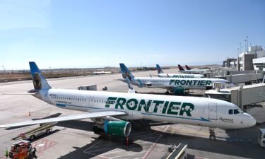 Frontier Airlines planes are parked at gates at Denver International Airport September 25