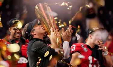 Georgia head coach Kirby Smart kisses the championship trophy after the national championship NCAA College Football Playoff game against TCU