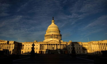 The rising sun creeps across the US Capitol dome in November 2022 in Washington