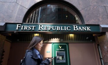 A pedestrian walks by a First Republic Bank office on March 16