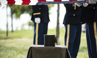 An urn containing the remains of Maj. Isaac C. Hart await burial during the service Thursday.