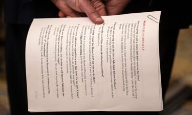Senate Majority Leader Chuck Schumer (D-N.Y.) holds sheets of paper with talking points on debt ceiling legislation during a press conference on Capitol Hill on May 2.