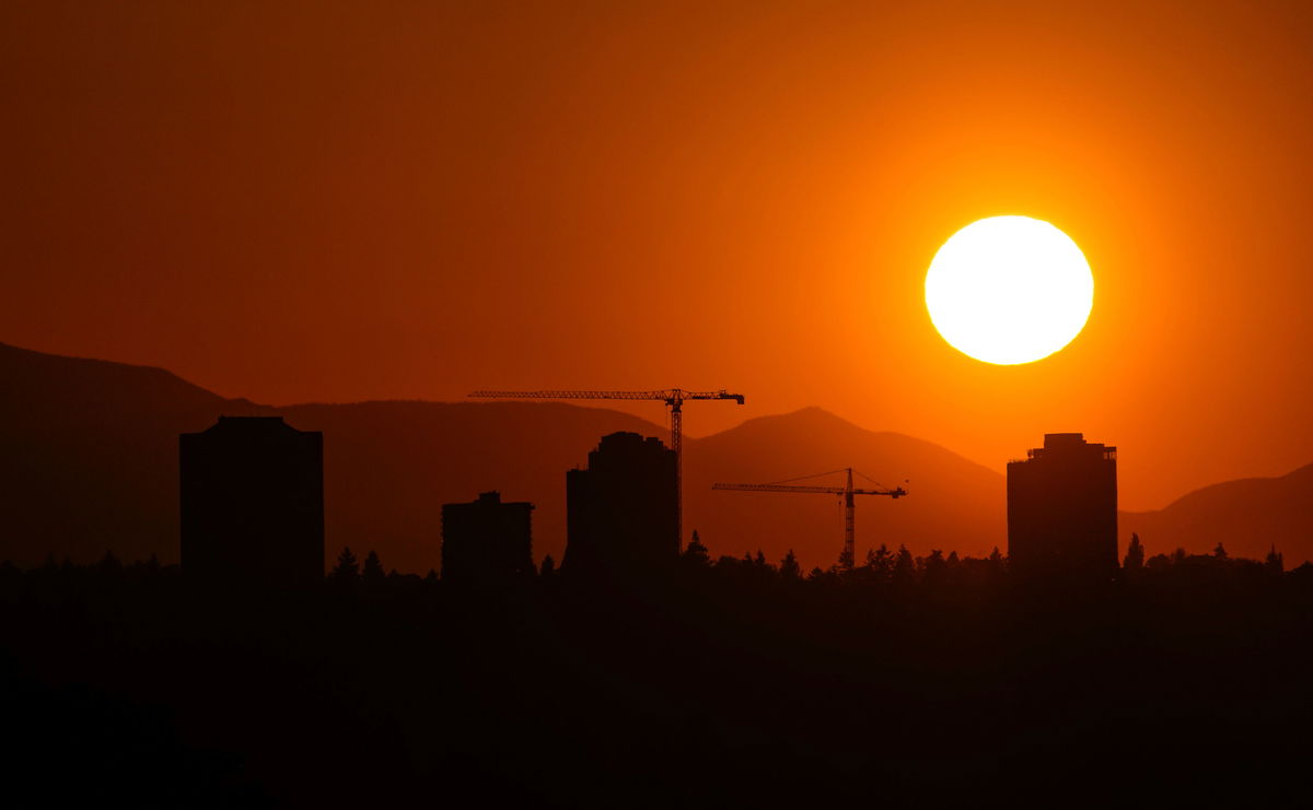 <i>Lindsey Wasson/AP</i><br/>The sun sets over the University District in Seattle