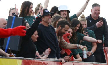 Wrexham co-owners Rob McElhenney and Ryan Reynolds celebrate during the victory parade.