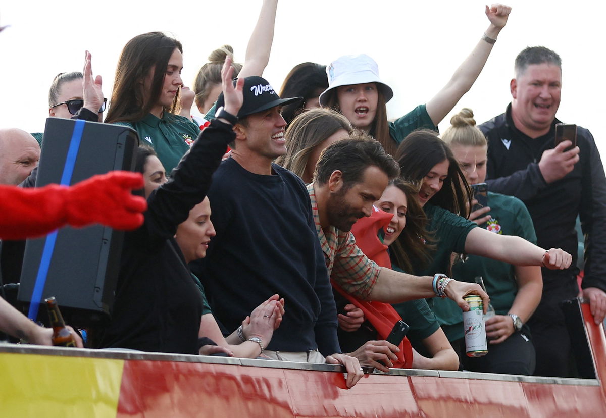 <i>Carl Recine/Reuters</i><br/>Wrexham co-owners Rob McElhenney and Ryan Reynolds celebrate during the victory parade.