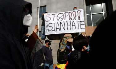 Protesters hold a sign during a rally in solidarity with Asian hate crime victims outside of the San Francisco Hall of Justice in 2021.