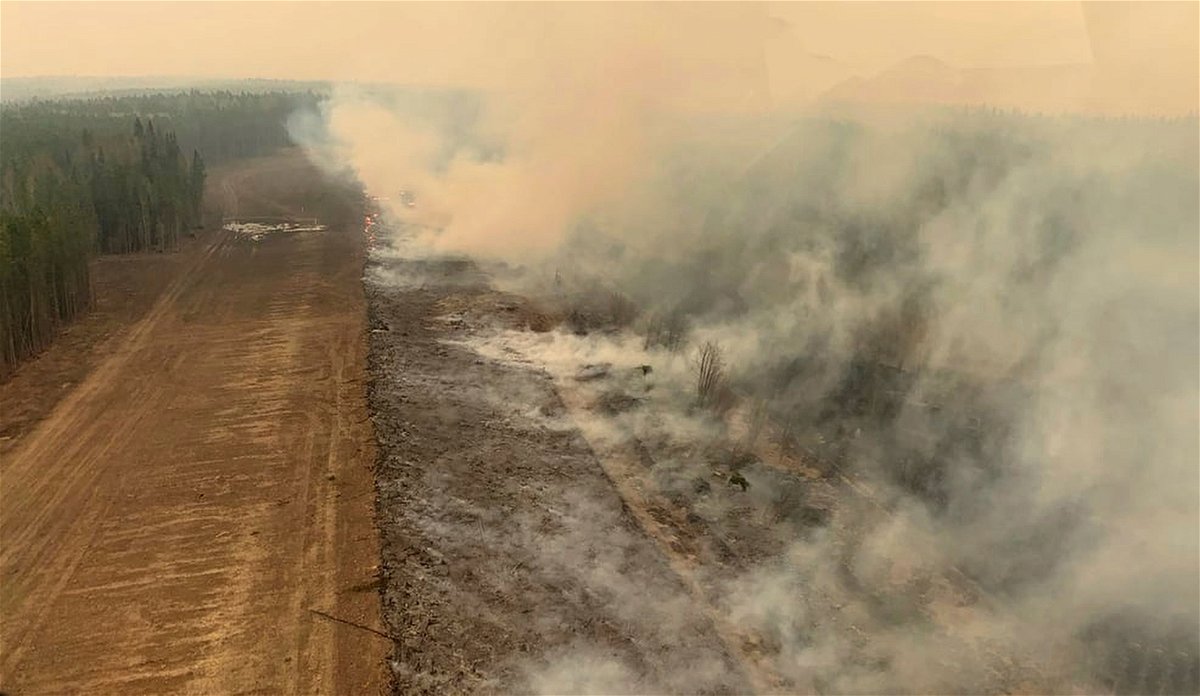 <i>Government of Alberta Fire Service/AP</i><br/>A burned section of forest smolders in the area near Edson