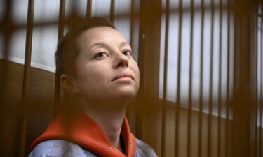 Yevgenia Berkovich sits inside a defendants' cage during her remand hearing in Moscow.