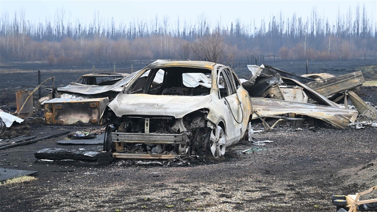 Damaged vehicles sit near the property of Adam Norris