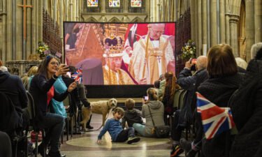 Members of the public inside Truro Cathedral watch a live screening of the Coronation of King Charles III and Queen Camilla on May 06