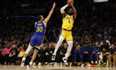 LeBron James #6 of the Los Angeles Lakers shoots the ball over Stephen Curry #30 of the Golden State Warriors during the first quarter in game six of the Western Conference Semifinal Playoffs at Crypto.com Arena on May 12