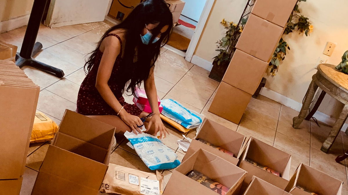 <i>Courtesy Jyoti Bhatnagar</i><br/>Emily Bhatnagar opening packages of books. She received so many books for her dad's birthday that they filled up her parents' bread shop in  suburban Maryland.